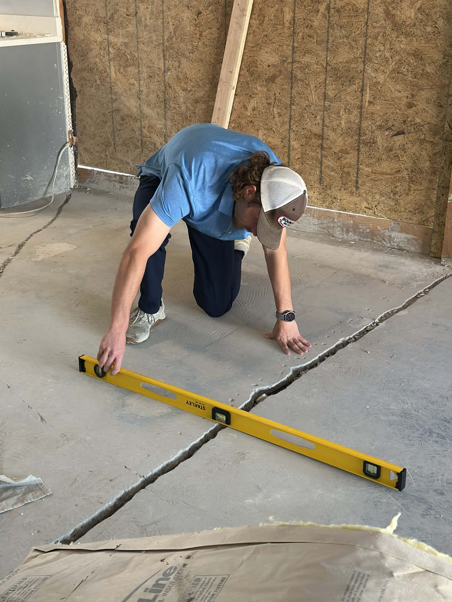 Inspector checking foundation with a level